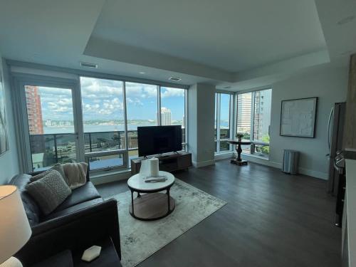 a living room with a couch and a tv at Waterfront downtown 1 Bedroom with 6 appliances in Halifax