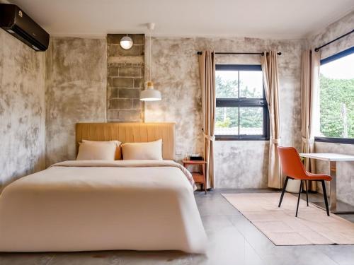 a bedroom with a large bed and a window at The Arch Casa - Design Hotel Pai ,Free Fast WiFi in Pai