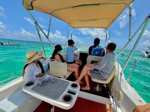 a group of people sitting on a boat in the ocean at punta excursiones the king of kings in Punta Cana