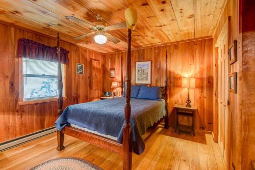 a bedroom with a bed in a room with wooden walls at On The River in Banner Elk
