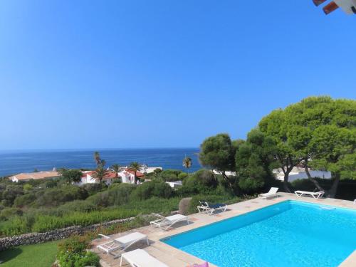een zwembad met uitzicht op de oceaan bij Binibeca Panorama incredibile in Sant Lluis