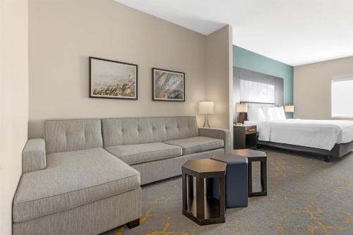 a living room with a couch and a bed at Best Western Plus Isanti in Isanti