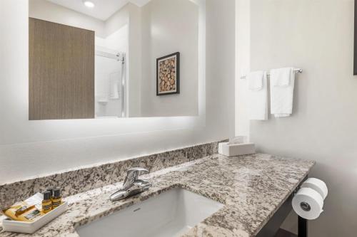 a bathroom with a sink and a mirror at Best Western Plus Isanti in Isanti
