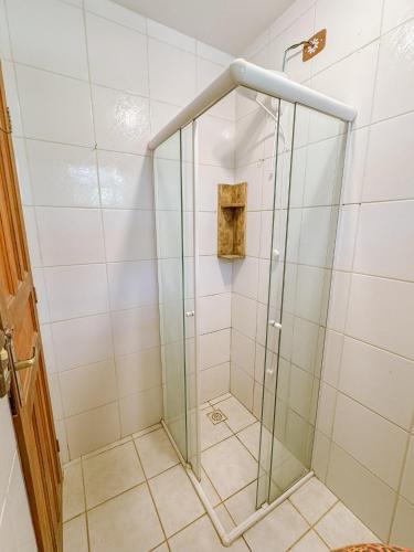 a shower with a glass door in a bathroom at Casa Floresta in Imbituba
