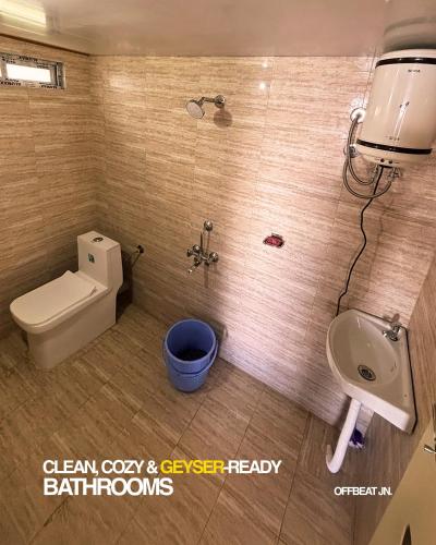 a bathroom with a toilet and a bidet and a sink at Offbeat Jn in Sukhia Pokhari