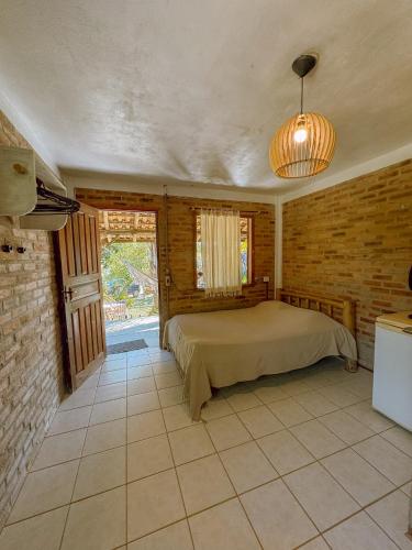 a bedroom with a bed in a room at Casa Floresta in Imbituba