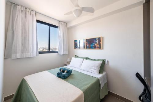 a bedroom with a bed with a blue camera on it at Apto Novo Centro SP Com Vista Panorâmica in Sao Paulo