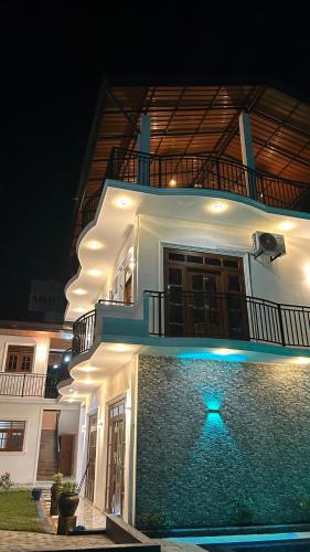a building with a blue light in front of it at Moonlit resort in Minuwangoda