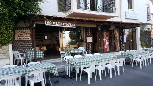 a group of tables and chairs in front of a restaurant at Chariandry Court in Pissouri