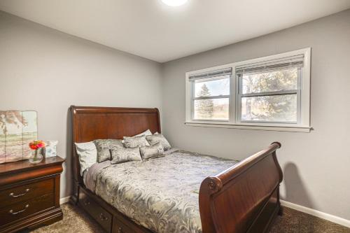 a bedroom with a bed and a window at 2 Mi to Pewaukee Lake! Peaceful Retreat with Yard in Pewaukee