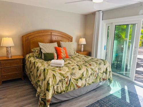 a bedroom with a bed with a wooden headboard at Siesta Key Beach House in Siesta Key