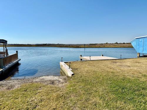 a dock on the side of a body of water at Canal front home on 3rd St. in Surf City, NC in West Onslow Beach