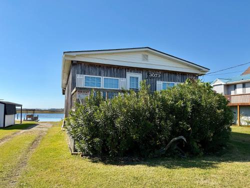 a house with a bush in front of it at Canal front home on 3rd St. in Surf City, NC in West Onslow Beach