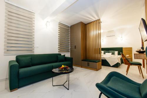 a living room with a green couch and a bedroom at Sahat Kula Residence Hotel in Ulcinj