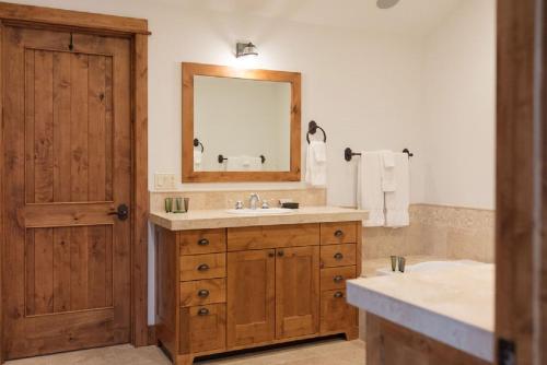 a bathroom with a sink and a mirror at Spacious 4BR home in Steamboat Springs, perfect for family getaways! in Steamboat Springs