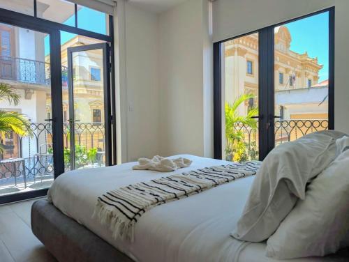 Ένα ή περισσότερα κρεβάτια σε δωμάτιο στο Casa Lourdes By Acomodocasco Viejo-large Groups!