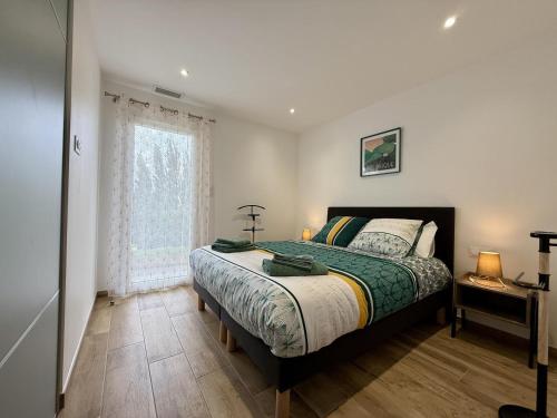 a bedroom with a bed and a window at Karrika buria in Saint-Martin-dʼArberoue