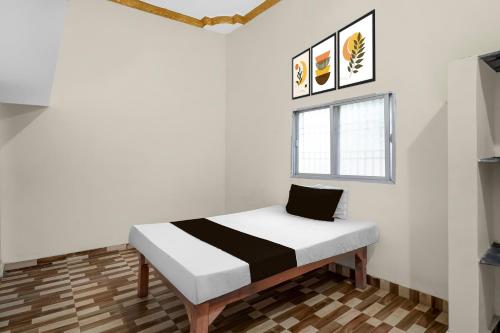 Ένα ή περισσότερα κρεβάτια σε δωμάτιο στο Hotel O Hamar Mitan