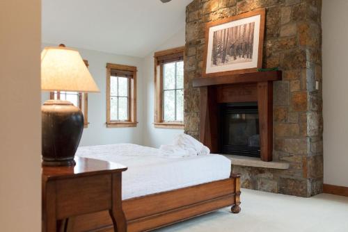 a bedroom with a bed and a fireplace at Spacious 4BR home in Steamboat Springs, perfect for family getaways! in Steamboat Springs