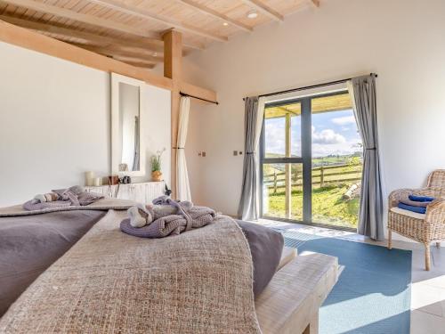 two beds in a bedroom with a large window at 1 Bed in Llandrindod Wells 53194 in Llandrindod Wells