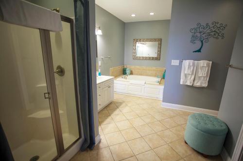 a bathroom with a shower and a sink and a tub at Reider Room at the Inn, Occano Arnold Palmer Signature Golf 