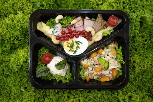 two plastic containers filled with food on a table at Aparthotel Merynos in Zakopane
