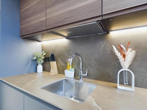 a kitchen with a sink and a counter top at Luxury Unique 2bedroom city centre in Manchester