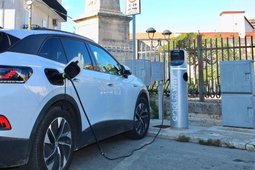 a white car is plugged into a parking meter at Terratetto - Apulia in Ceglie Messapica