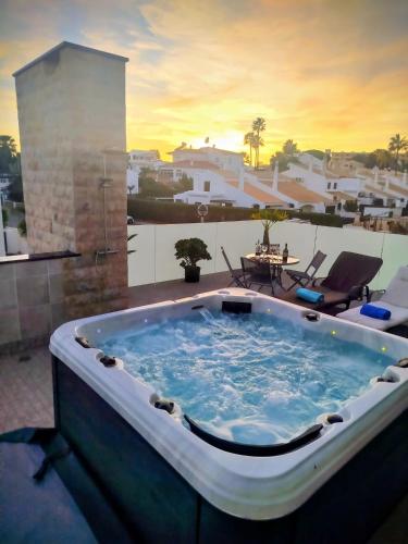 a jacuzzi tub on a patio with a view at Villa Luz 37 - Jacuzzi Terrace & Swimming Pool in Albufeira