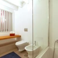 a bathroom with a toilet and a glass shower at Casal de Palácios in Bragança