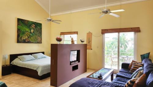 a living room with a bed and a couch at Ocean Dream High Ceiling Studio w/balcony in Cabarete