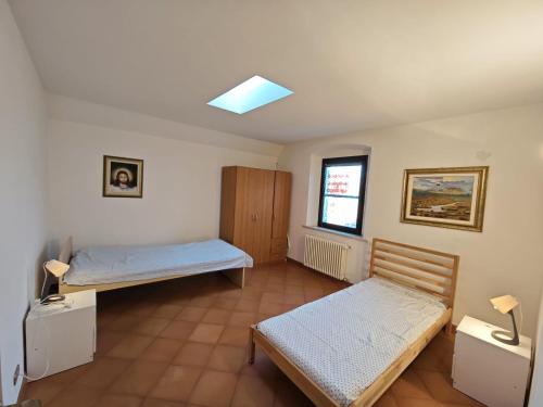 Ένα ή περισσότερα κρεβάτια σε δωμάτιο στο Corte degli Artisti