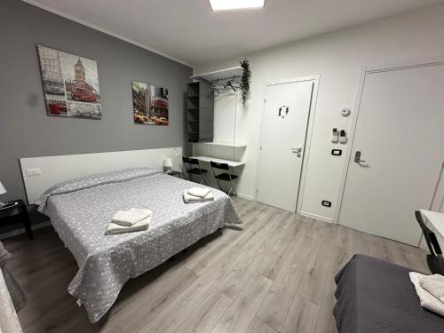 a bedroom with a bed with two towels on it at B&B Le Palme Fiera in Bologna