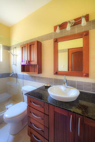 a bathroom with a sink and a toilet at Ocean Dream High Ceiling Studio w/balcony in Cabarete