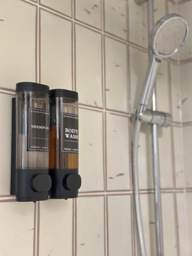two bottles ofodorizers on a wall in a bathroom at Louis Haus in Lahnstein