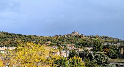 a castle on top of a hill with trees at Historic Dover Stay with Stunning Castle View in Dover