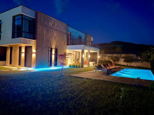 a house with a swimming pool at night at Villa Saguramo in Saguramo