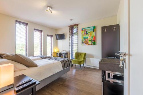 a bedroom with a large bed and a bathroom at Casa Mirador Sleep Inn in Almere