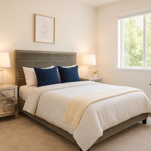a bedroom with a large bed with blue pillows at Modern Private Room with Private Bath in Manteca
