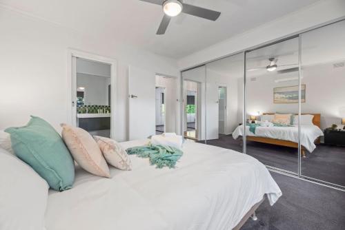 Relax Unwind in Berwick Multiple Retreat Walk to shops في بيرويك: غرفة نوم بها سرير أبيض كبير مع وسائد