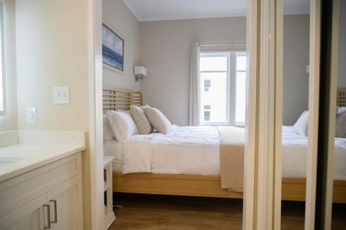 a bedroom with a bed and a mirror at Coastal Luxury Studio One Block to Big Rock in Morehead City