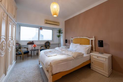 ein Schlafzimmer mit einem Bett mit Lampe und einem Schreibtisch in der Unterkunft 18th floor Nile View with Jacuzzi in Zamalek in Kairo