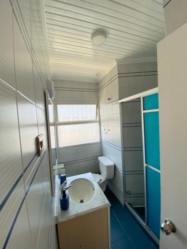 a bathroom with a sink and a toilet at Habitaciones Mar Azul in El Quisco