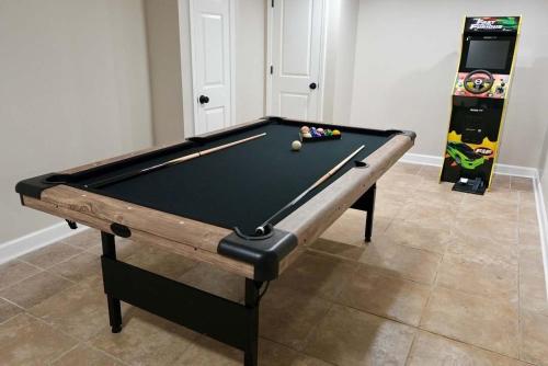 a pool table sitting in a room with a game at Modern Stylish Comfort Near Casino and Hwy in East Hazel Crest
