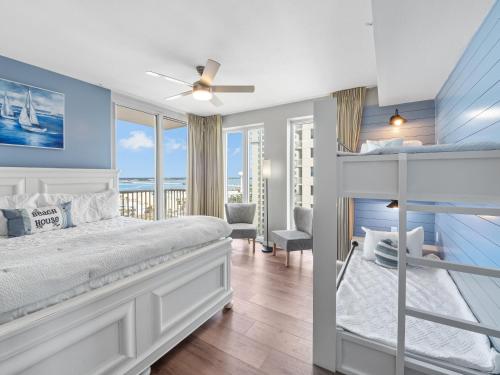 a bedroom with a bunk bed with a view of the ocean at Mermaid Manor in Navarre