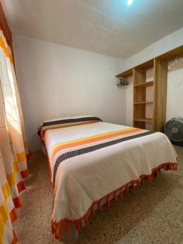 a bedroom with a bed in a room at Casa Magro depto 1er piso para 6 in Oaxaca City