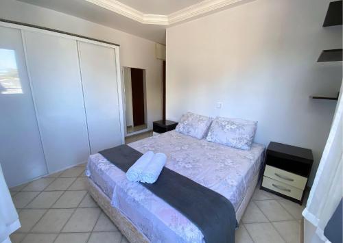 a small bedroom with a bed with blue sheets at Apartamento recantoazul es Conforto Total a 50m do Mar Apartamento Recém-Reformado na Praia de Castelhanos, ES, para 7 Pessoas Aconchegante e Completo, com 3 Quartos e 1 Suíte in Anchieta