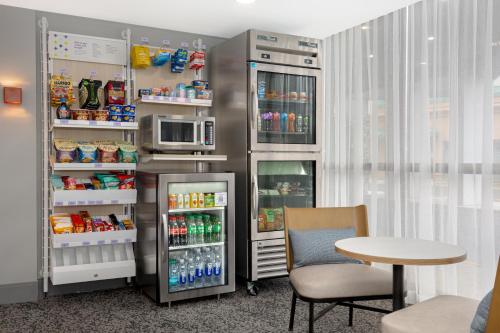 a room with a refrigerator and a table and a microwave at Spark by Hilton Toronto Airport in Toronto