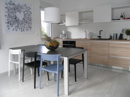 a kitchen with a dining room table and chairs at Apartments Mon Amour in Dubrovnik