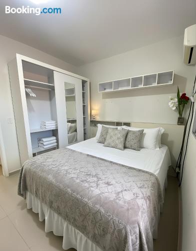 a white bedroom with a large white bed with pillows at Casa privada 3 quartos ótima localização in Piranhas